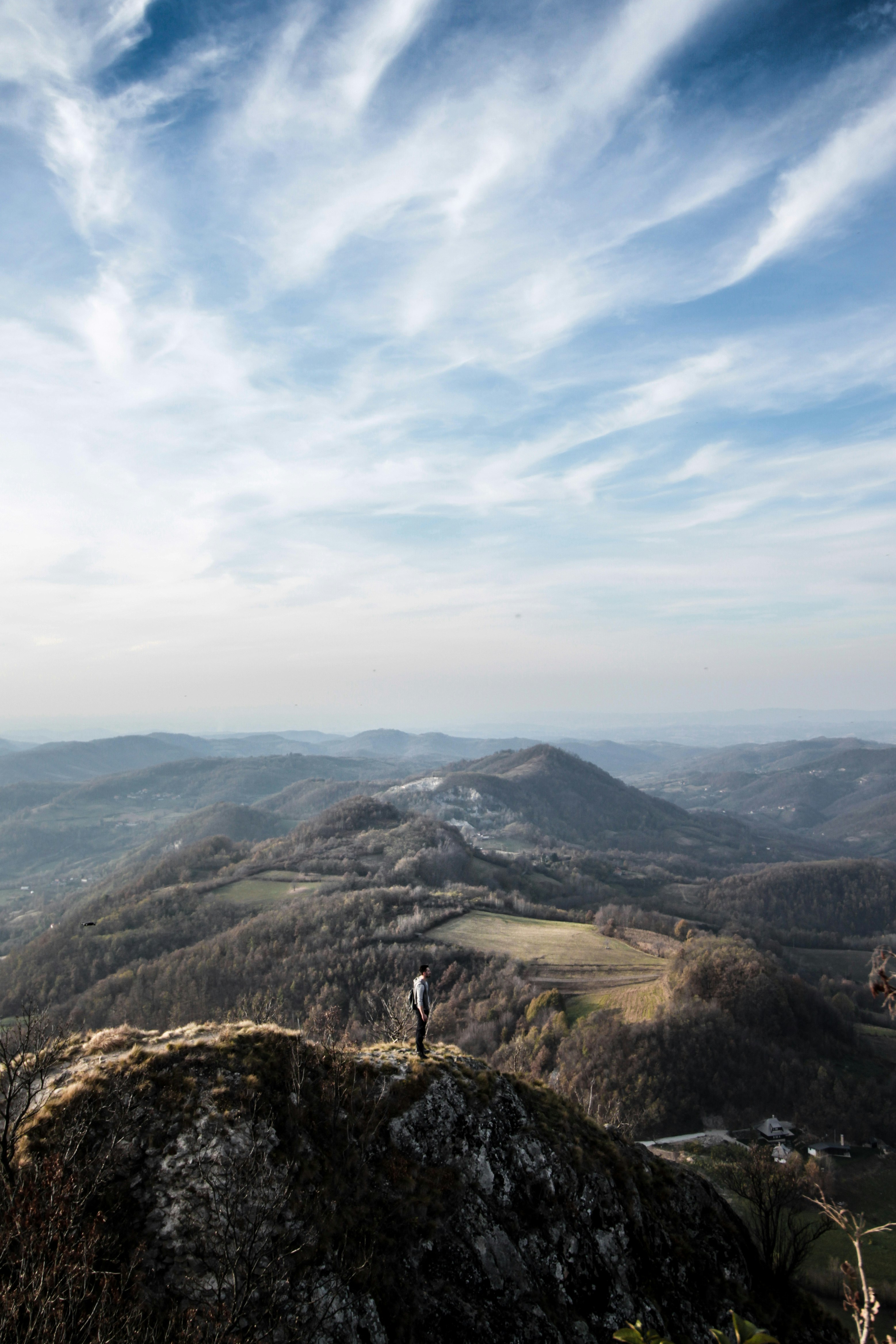 person standing on top of mountain during daytime